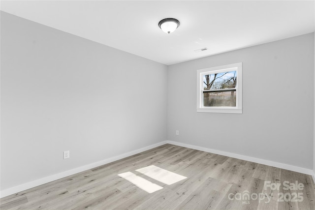 spare room featuring light hardwood / wood-style floors