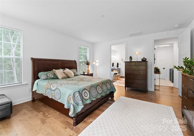 bedroom featuring multiple windows and hardwood / wood-style floors