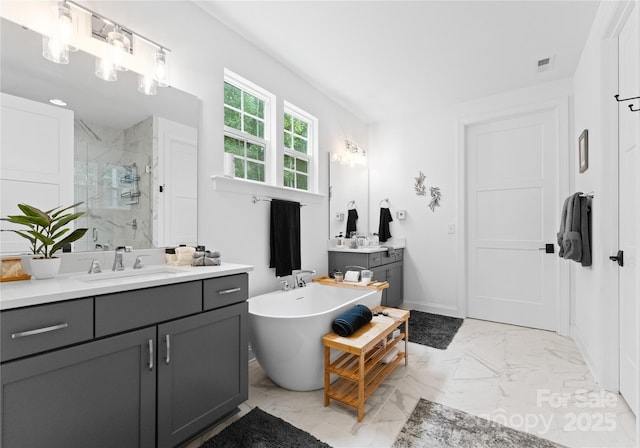 bathroom with vanity and shower with separate bathtub