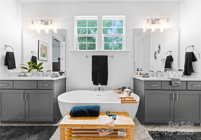 bathroom with vanity and a bath