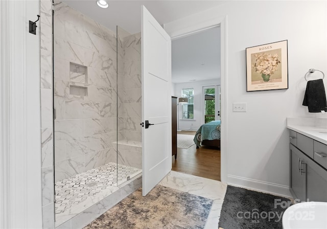 bathroom featuring vanity and a tile shower