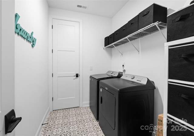 clothes washing area featuring washer and clothes dryer