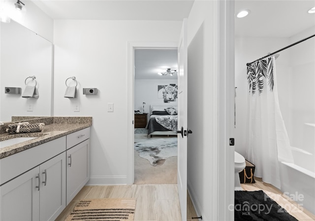 full bathroom featuring vanity, toilet, and shower / bathtub combination with curtain