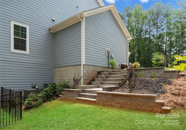 view of side of home featuring a lawn