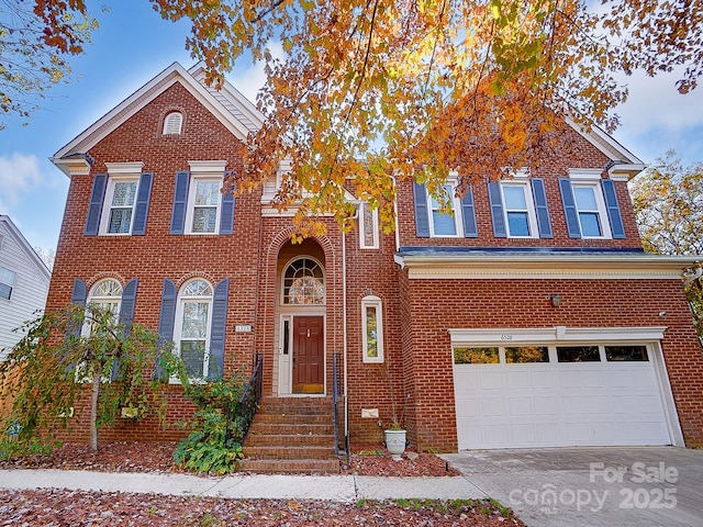 view of front of house featuring concrete driveway, brick siding, and an attached garage