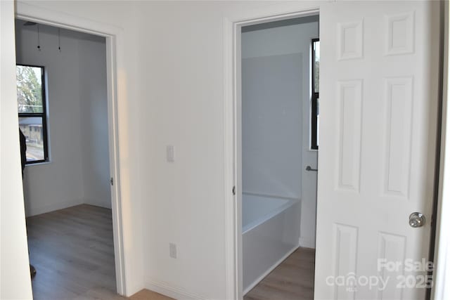 corridor with light hardwood / wood-style floors