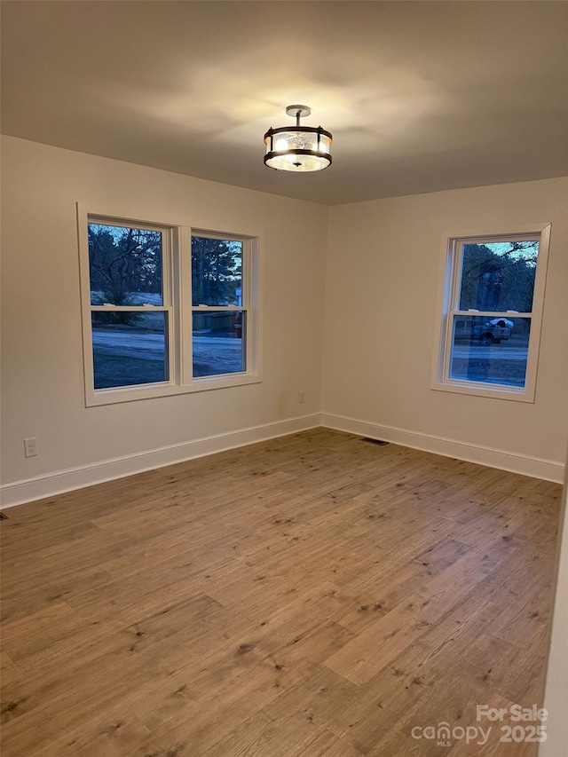 unfurnished room featuring wood-type flooring