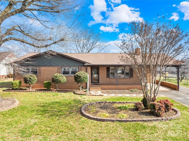 ranch-style house with a front yard and a carport