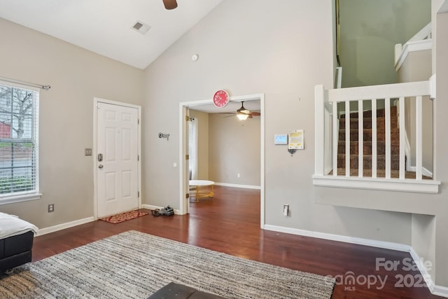 entryway featuring dark wood-type flooring, ceiling fan, and high vaulted ceiling