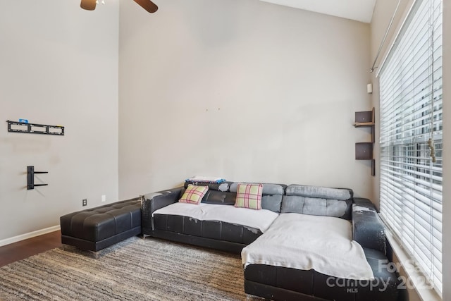 living room featuring wood-type flooring and ceiling fan