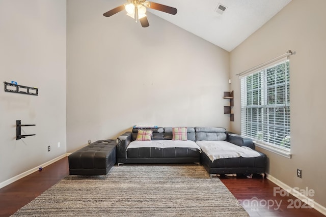 living room featuring dark hardwood / wood-style flooring, high vaulted ceiling, and a healthy amount of sunlight