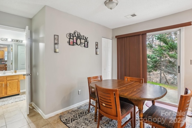 tiled dining room with sink