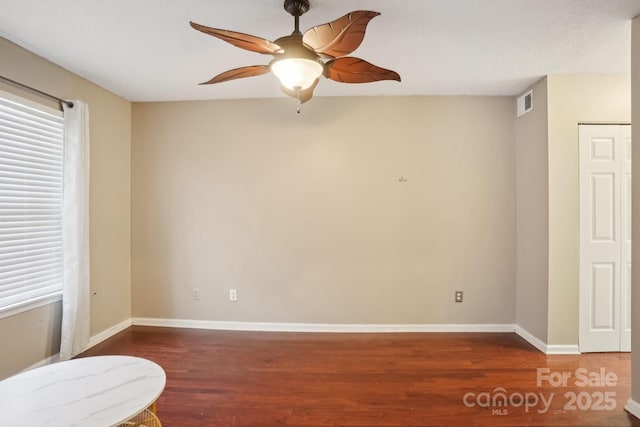 unfurnished room with dark hardwood / wood-style floors and ceiling fan