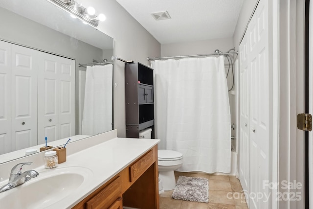 full bathroom featuring vanity, shower / tub combo with curtain, tile patterned floors, and toilet