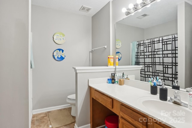 bathroom with vanity, tile patterned floors, and toilet