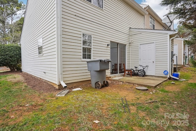 rear view of house with a patio area and a lawn