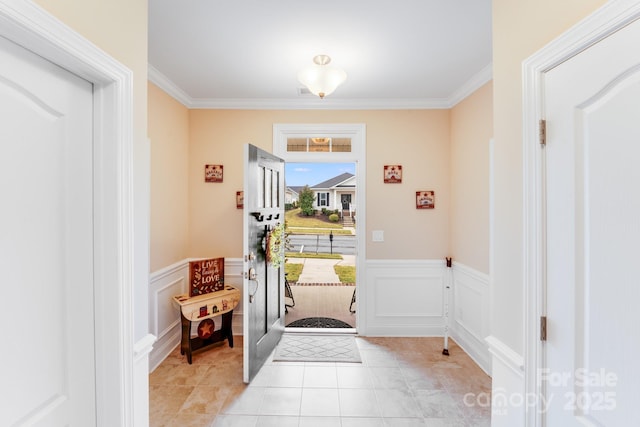 entryway featuring crown molding and light tile patterned floors