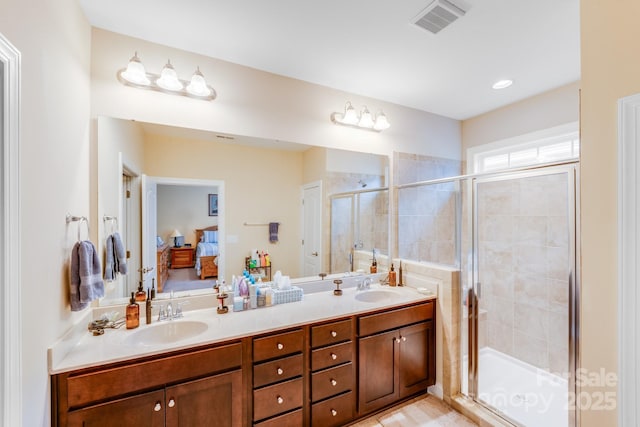bathroom with a shower with door and vanity