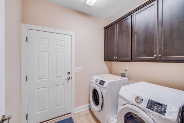 washroom with cabinets, washing machine and dryer, and light tile patterned flooring