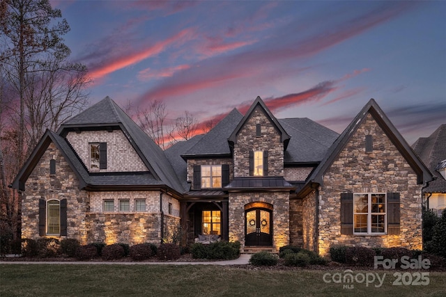 french country home featuring french doors, roof with shingles, metal roof, and a standing seam roof