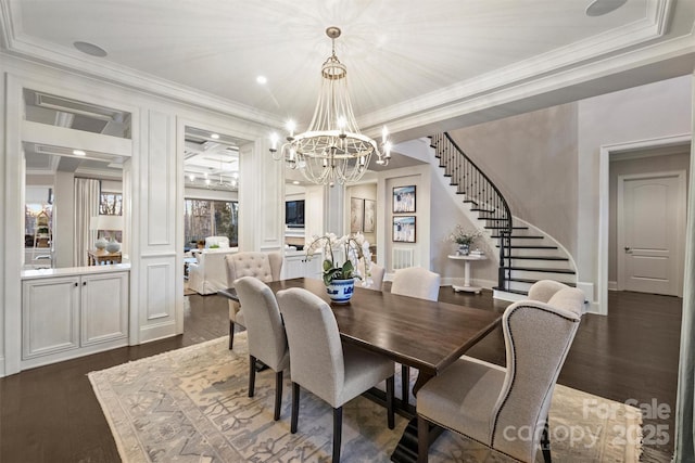 dining room with ornamental molding, a chandelier, and dark hardwood / wood-style flooring