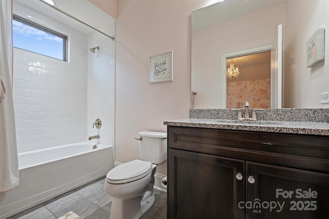 full bathroom featuring tiled shower / bath, vanity, and toilet