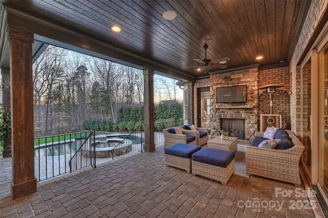 view of patio / terrace featuring an outdoor living space with a fireplace