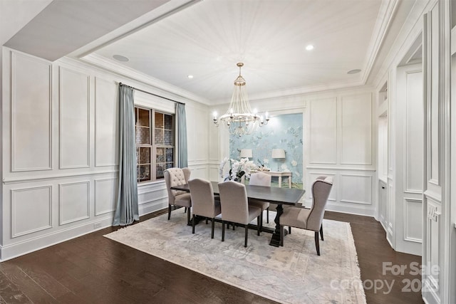 dining area with crown molding, a notable chandelier, recessed lighting, a decorative wall, and dark wood-type flooring