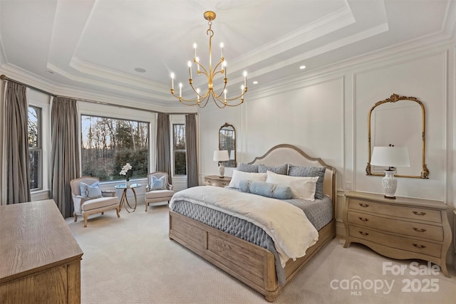 bedroom featuring multiple windows, a tray ceiling, and light colored carpet