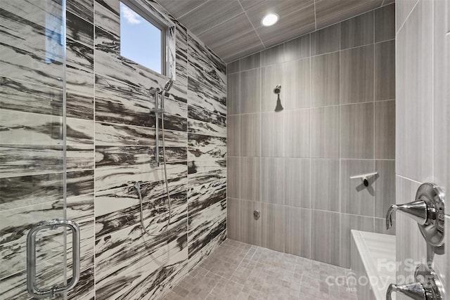 bathroom with a shower stall and recessed lighting