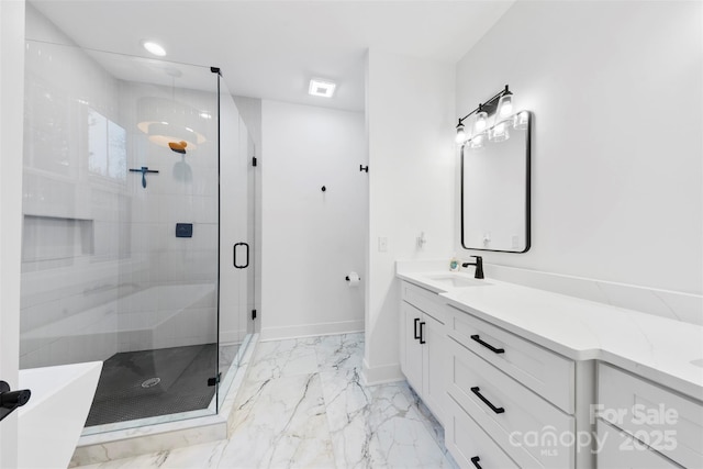 bathroom with vanity and a shower with door