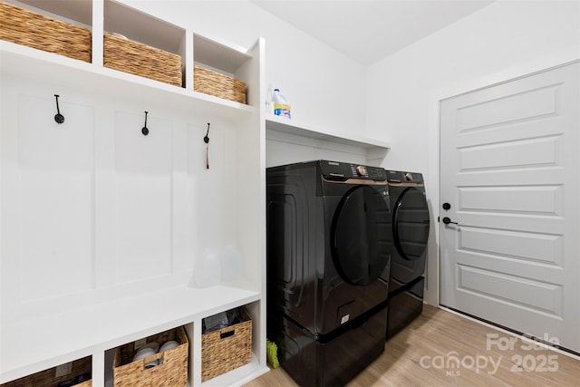 mudroom with washer and dryer and light hardwood / wood-style flooring