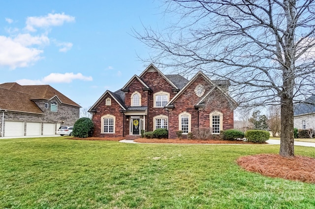 view of front of property with a garage, a front lawn, and brick siding