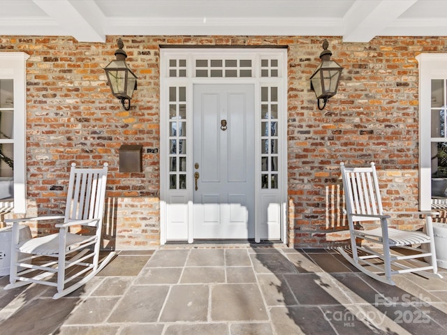 view of exterior entry with covered porch