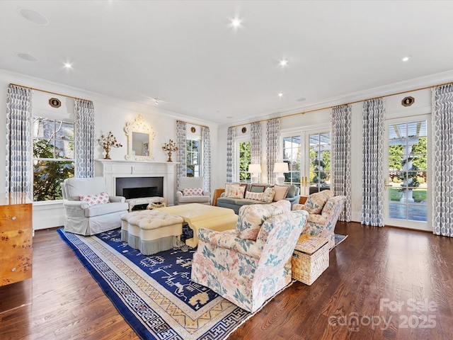 living room with recessed lighting, ornamental molding, a fireplace, and dark wood finished floors