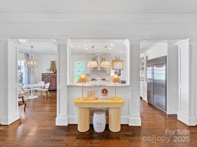 kitchen with dark wood-style floors, decorative columns, and stainless steel built in fridge