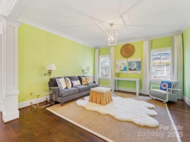 living area featuring ornate columns, ornamental molding, a healthy amount of sunlight, and wood finished floors