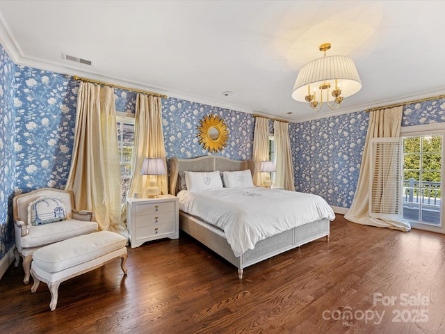 bedroom featuring crown molding, wallpapered walls, wood finished floors, and visible vents