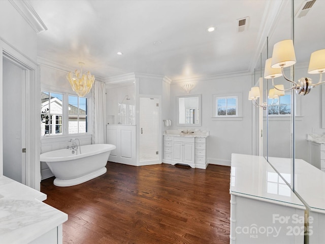 full bath with crown molding, an inviting chandelier, visible vents, and vanity