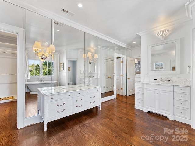 full bath with visible vents, ornamental molding, wood finished floors, and a notable chandelier