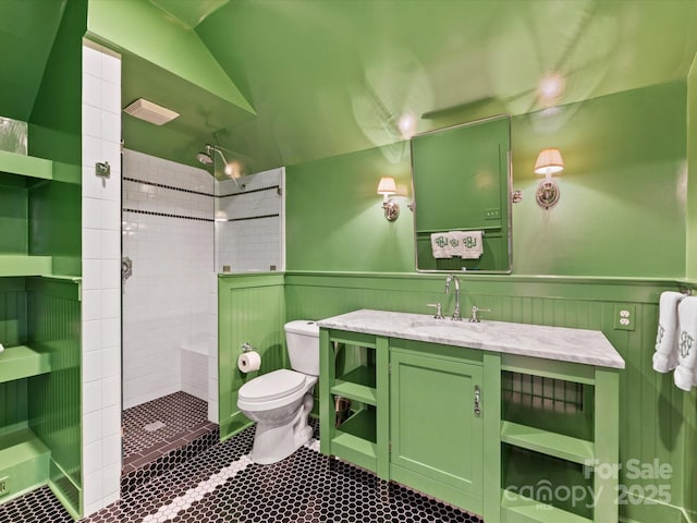 full bath featuring vanity, lofted ceiling, toilet, tile patterned floors, and a tile shower