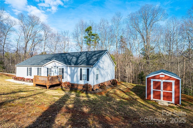 view of front of house with a front lawn, a deck, and a storage unit