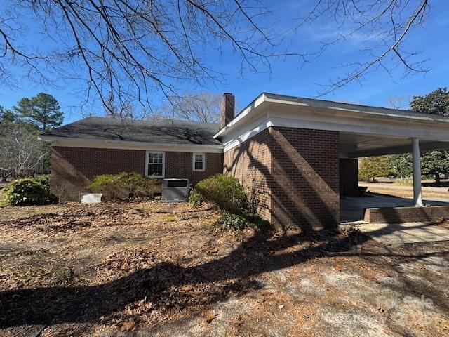 view of side of property featuring a carport