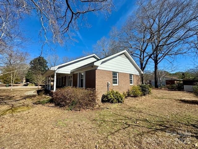 view of property exterior with a lawn