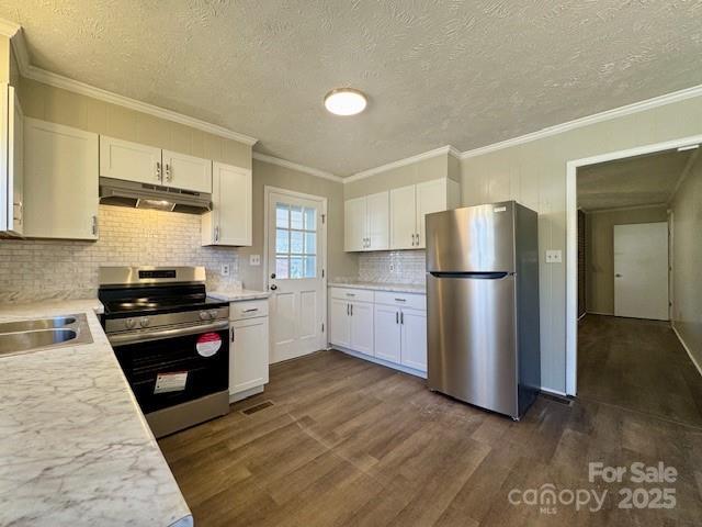 kitchen with appliances with stainless steel finishes, sink, white cabinetry, dark hardwood / wood-style floors, and crown molding