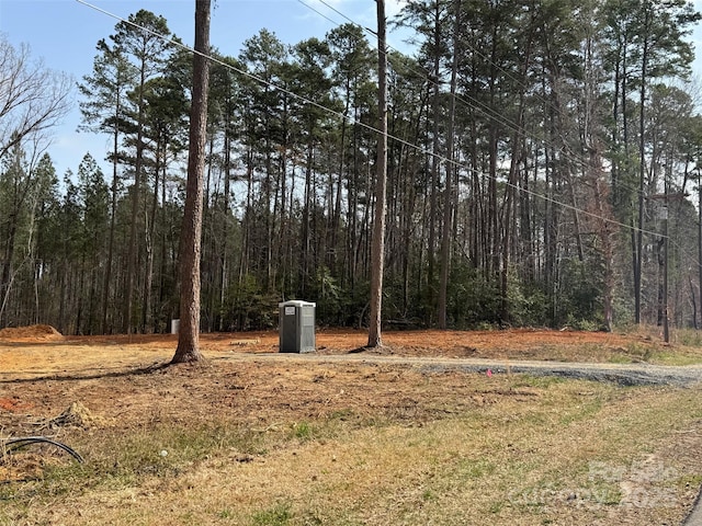 view of yard with a forest view