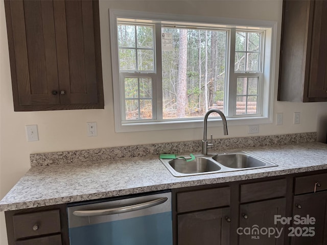 kitchen featuring a sink, dark brown cabinets, light countertops, and stainless steel dishwasher