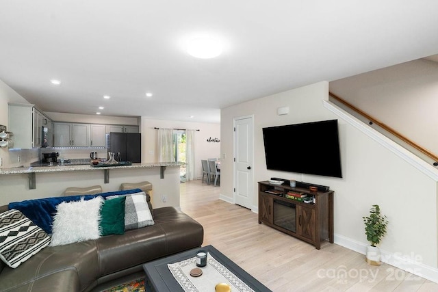 living room with light hardwood / wood-style flooring