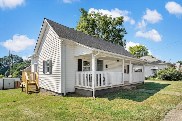 bungalow-style house with a shed, covered porch, and a front yard