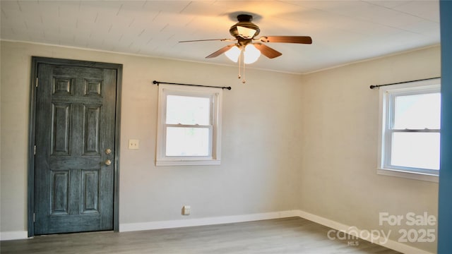 spare room featuring hardwood / wood-style flooring and ceiling fan